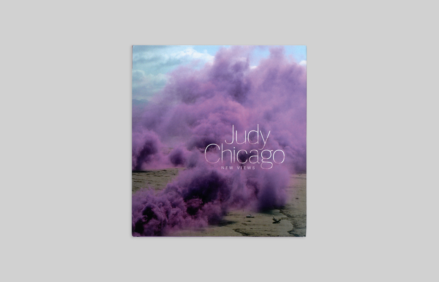 Cover of Judy Chicago: New Views has a detail from Purple Atmosphere, a fireworks performance that released a purple cloud.
