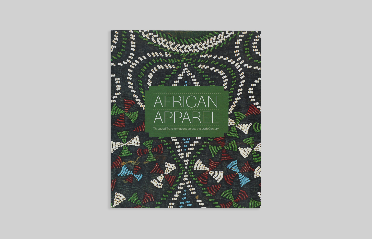 Exhibition catalogue cover features a detail from a beaded shirt from Bamileke, Cameroon.
