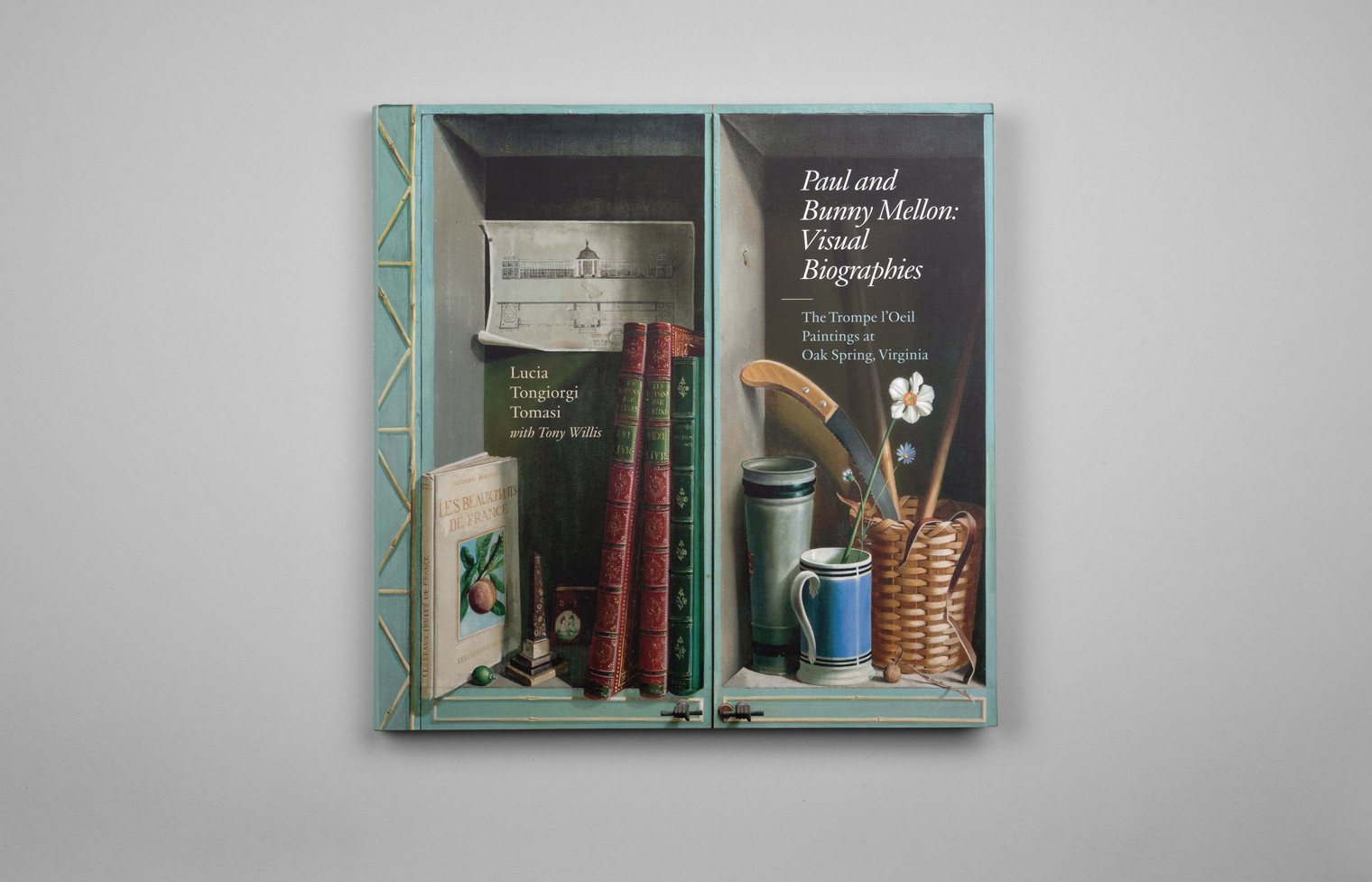Book cover with a detail of a trompe l'oeil painting showing shelves with various items including books and a cup.