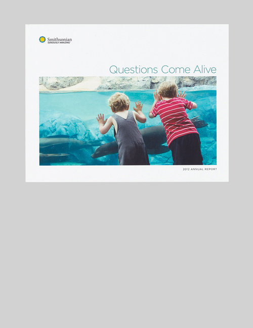 The cover of the 2012 SI Annual Report shows two children marveling at seals at an aquarium.
