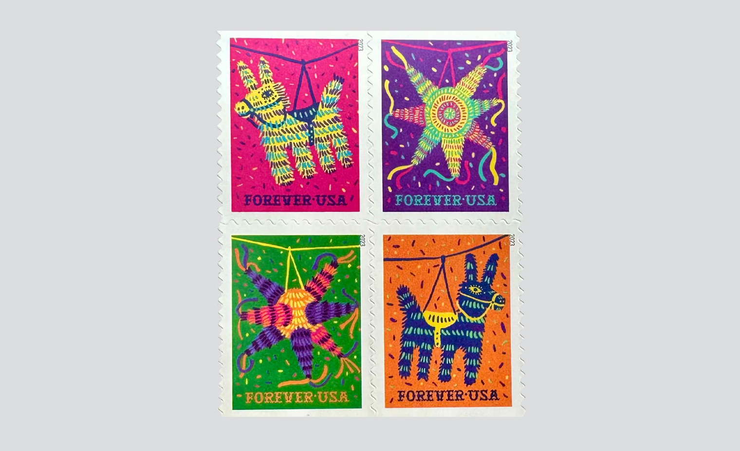 The stamp art features four digital illustrations of two traditional piñata designs — a donkey and a seven-pointed star. The bright, saturated color palette was inspired by Mexican culture, including the vibrant colors of small-town houses, traditional hand-sewn dresses, handmade toys and flowers, and classic piñatas themselves. The donkey illustrations are set against either a pink or orange background; the stars feature either a purple or green background. The background colors add to the exuberant and celebratory feel of the stamps.